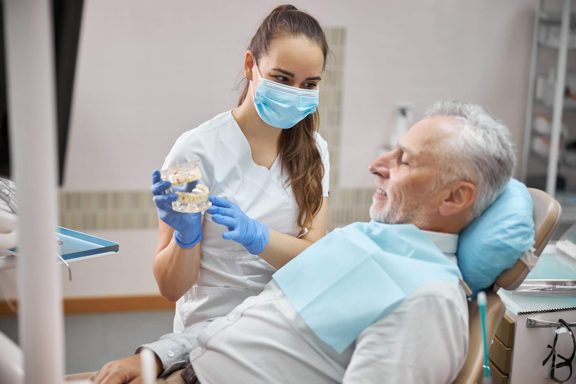 Naples Dentists 5 qualified female dental specialist holding dental implants.jpg